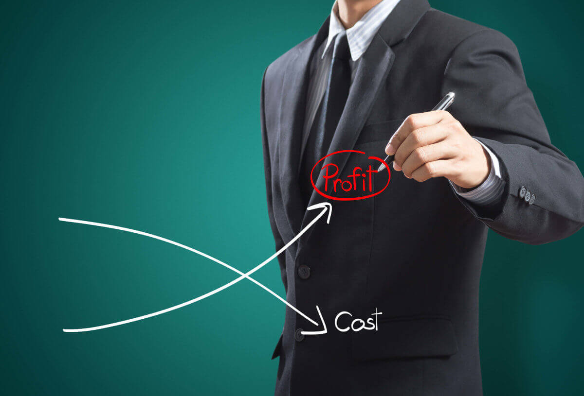 Business man drawing graph of profit compare with cost